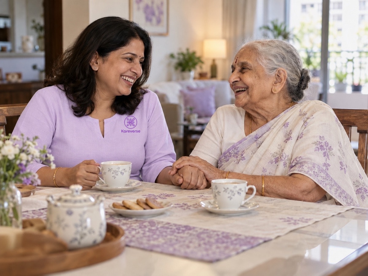A KareGuardian sharing tea and a laugh with an older woman